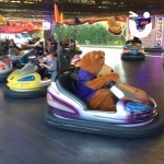 Dodgems Hire 2 at a fun day being used by children and Fun Bear driving after them
