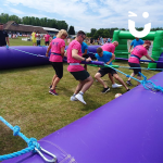 Red and pink team competing in the human Table Football