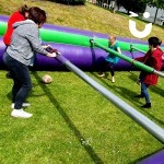 Adults challenge children on the human table football