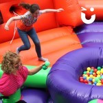 A women and girl smiling on the Hungry Hippos Inflatable Hire