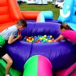 A boy and girl playing on the Hungry Hippos Inflatable Hire