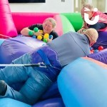 Hungry Hippos Inflatable Hire at an indoor corporate team build being used by competitive colleagues