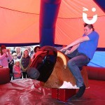 A guest riding the Rodeo Hire under the Inflatable Canopy Hire 