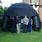 People observing from beyond the Inflatable Canopy Hire 