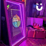 The Magic Selfie Mirror Hire lit with purple lights