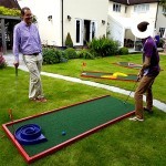 man and young boy on the mini golf