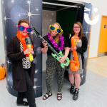 Event guests wearing props and posing outside of our Photobooth