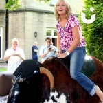 `A women riding the Rodeo Bull Hire