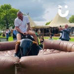 Rodeo Bull Hire at a daytime function with a man having a go!