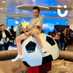 Child riding the Rodeo Football at an indoor event