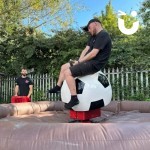 Rodeo Football Inflatable At An Outdoor Corporate Family Fun Day