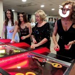 Women at a corporate event enjoying the festive vibe of the Roll A Ball Reindeer Hire