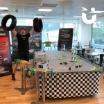 Scalextric Track Hire for a Corporate event with a Fun Expert excitedly showing off his tyre props
