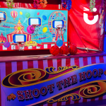 Shoot the Hoop Side Stall lit up at an indoor evening event