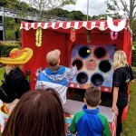 Ball In A Bucket Hire 3 at a family fun day with a family trying their best to win a fun novelty prize