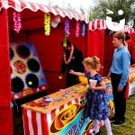 Little girl on the Ball in a Bucket stall