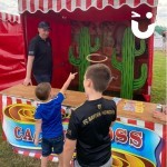 Cactus Stoss Stall Hire at a corporate fun day with 2 young boys giving it a shot to win a prize