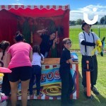Cactus Stoss Stall Hire at a community fun day with a family gathered around the stall to win a prize