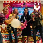 Cork Shoot Hire Image at a corporate party with 4 colleagues excitedly posing with prizes they've won