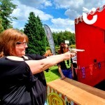 Cork Shoot Hire Image at a corporate fun day with a woman taking fire