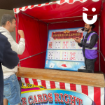 Edge Hill student celebrating a win at the Play Your Cards Right Stall