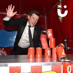 Man throwing a bean bag at the Tin Can Alley Stall Hire