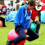 A man on the Space Hoppers Hire carrying a Bean bag under his chin