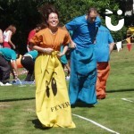 man and women on the sack race during a sports day