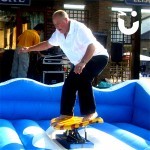man i[n white shirt on the surf simulator