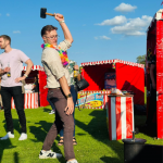 Man wearing a lei having a go at the Test of Strength