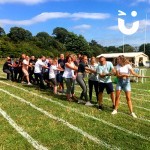 Guests of a company fun day get ready to partake in a traditional game of Tug of War