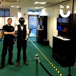 Fun Expert Adrian assists a guest using the Virtual Reality Experience who is about to go head to head with a colleague.