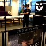 Fun Expert Ben straps on the HTC Vive VR headset to show guests how to interact with the VR experience