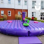The Wipeout on hire for a student event, taking centre stage. The inflatable challenge is ready for guests to take on the sweeper arms