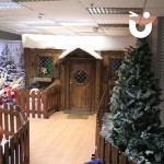 A view of Santa's Wooden Grotto through the trees