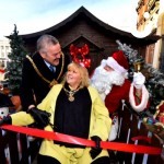 Santa outside Santa's Wooden Grotto posing with the Mayor
