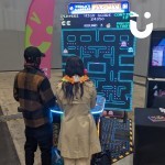 World's largest Pacman at an ex ithibition with 2 very happy ladies posing with a 2 people playing