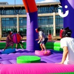 Close up of party guests having fun on The Inflatable Wrecking Ball available for hire from Sunshine Events