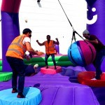 Guests enjoying the inflatable wrecking ball at a company fun day event for staff