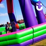 Children playing on the Inflatable Wrecking Ball at a family fun day in the North West