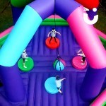 Drone shot looking down on participants in the Wrecking Ball inflatable on hire from Sunshine Events for a school event.