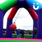 The Wrecking Ball Inflatable on hire at a family fun day entertaining guests