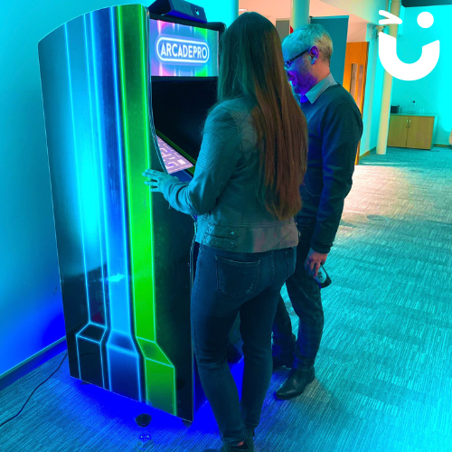 Two people playing games on the Arcade Machine