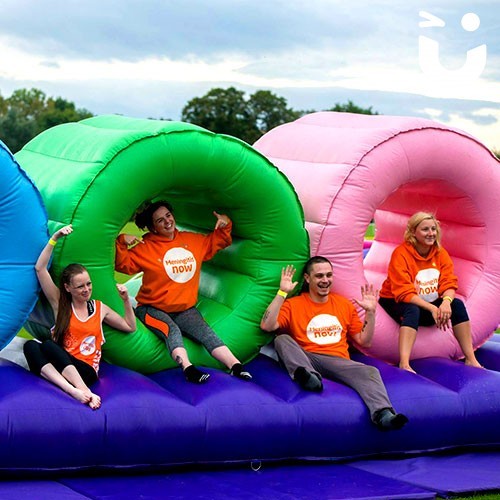 people posing with the Assault Course Tunnels during a team building day