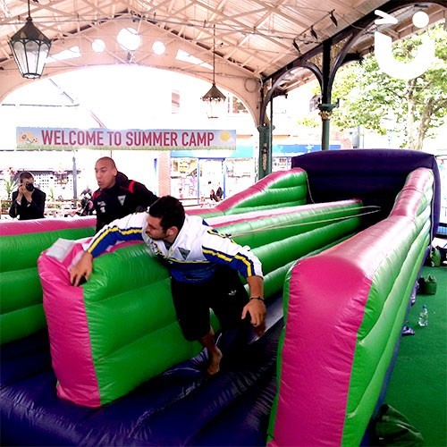 two men competing against each other on the Bungee Run Hire