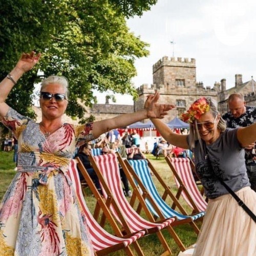 Deckchairs at a corporate family fun day with 2 dancing women