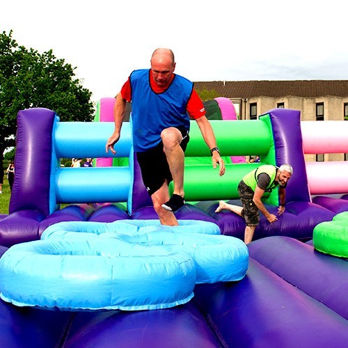 a man from booths running on the inflatable tires