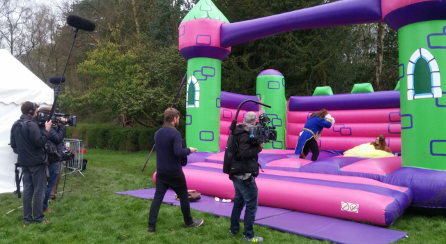 Don't Tell The Bride crew filming the bride and groom dressed as Beauty & the Beast on our Event Bouncy Castle