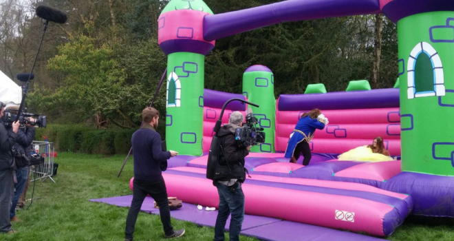 Don't Tell The Bride crew filming the bride and groom dressed as Beauty & the Beast on our Event Bouncy Castle