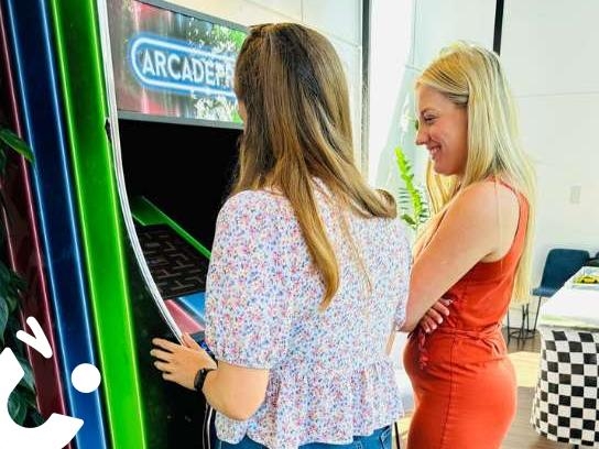 Arcade Machine being enjoyed by 2 friends at an indoor party